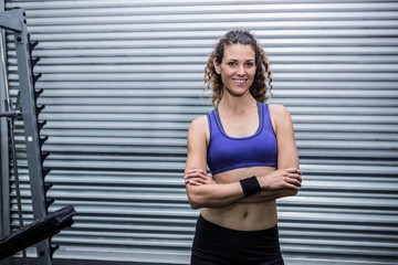 Portrait of muscular woman with arms crossed