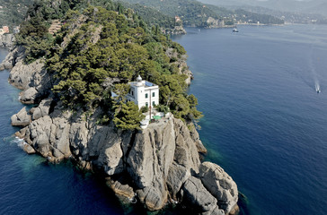 Lighthouse on the rocky coast of the promontory of Portofino
