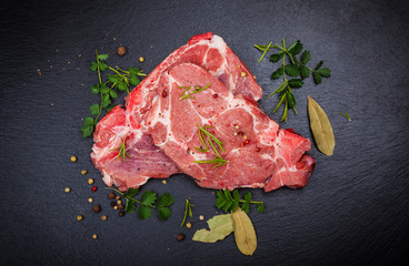 Fresh raw meat on black board