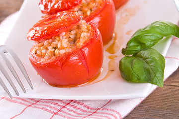 Stuffed tomatoes on a white plate. 