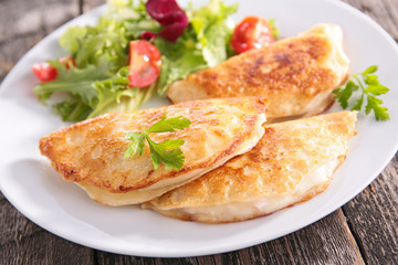 salad and crepe with cheese and ham