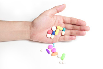 hand hold many medicine, boxes of medicines in the background