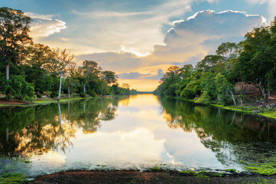 Sunset over ancient moat surrounding Angkor Thom, Cambodia