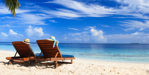 Two chairs on the tropical beach - 87144456