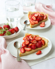 Tart with Greek yogurt and fresh strawberries on textiles