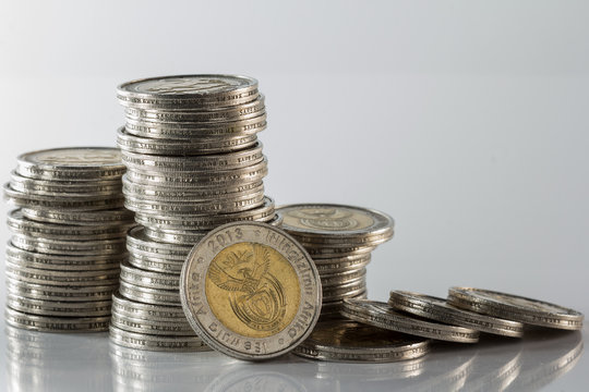silver coins piled against white background