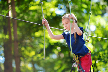 Little girl enjoying her time in adventure park