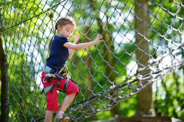 Little girl enjoying her time in adventure park