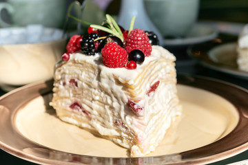 Delicious cake with berries and mascarpone on plate on table close up