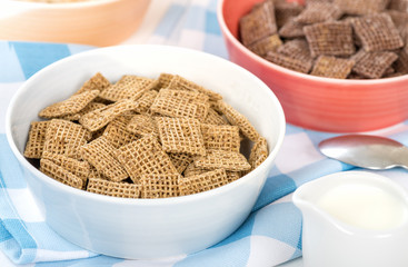 Shreddies - Whole grain wheat cereals in a bue bowl.

