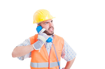 Angry builder having a conversation on the phone