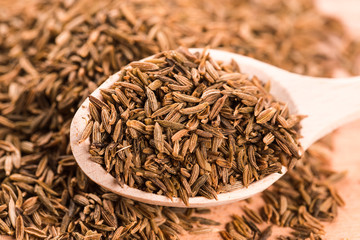 Cumin seeds in wooden spoon