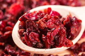 Dry red barberry spices in the wooden spoons