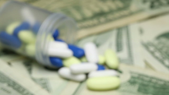 Focus shift pills on money - healthcare cost concept