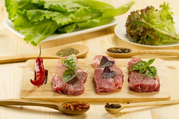 fresh raw pork on cutting Board with spices and herbs