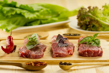 Fototapeta na wymiar fresh raw pork on cutting Board with spices and herbs