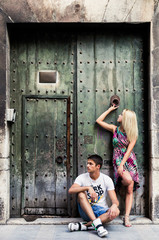 fashion portrait of a beautiful couple near old door