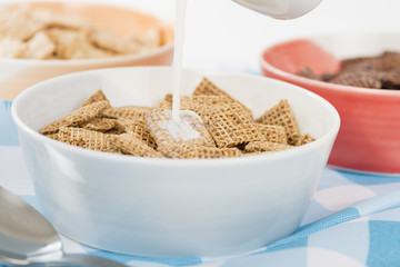 Shreddies - Whole grain wheat cereals in a bue bowl.

