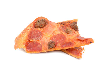 two slices leftover pizza on white background