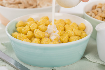 Golden Nuggets - Whole grain cereals in a green bowl.
