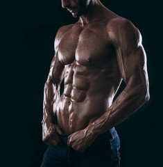 Fototapeta na wymiar muscle man torso on black background, bodybuilding athlete portr