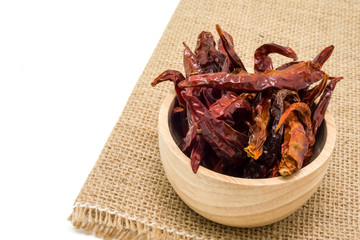 Dried chili in wooden bowl isolated on white background