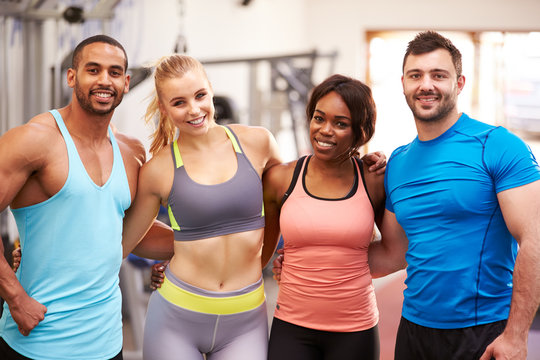 Happy Group Of Gym Buddies With Arms Around Each Other