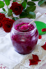 Rose petal jam and sugar on a wooden table