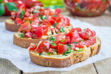 Bruschetta with tomatoes, herbs and oil on toasted garlic cheese bread