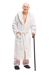Senior man in a bathrobe holding a cane