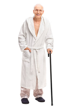 Senior Man In A Bathrobe Holding A Cane