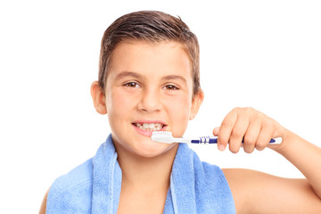 Little boy brushing his teeth with a toothbrush