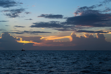 Obraz na płótnie Canvas Fishing boats at sea at twilight