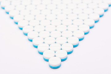 white and blue tablets pills on white background