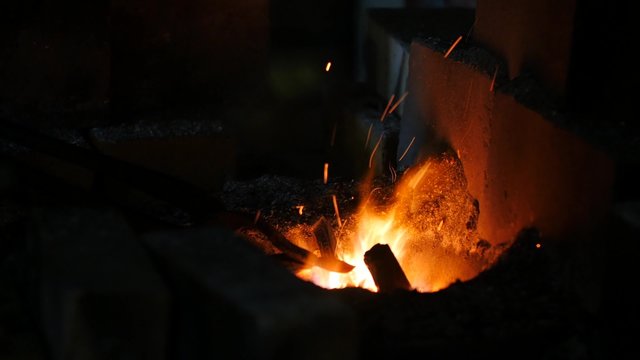 Blacksmith work with metal and fire forge