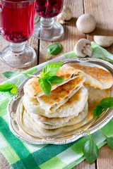 Pastry stuffed with mushrooms and onions on a wooden table