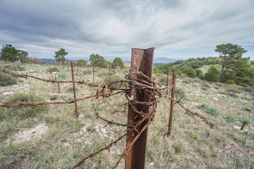 Abandoned military zone with rusty spiked fence