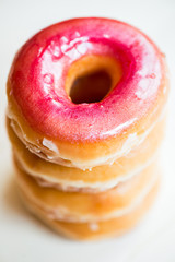 Stack of Glazed Doughnuts with colourful sprinkles, chocolate, i
