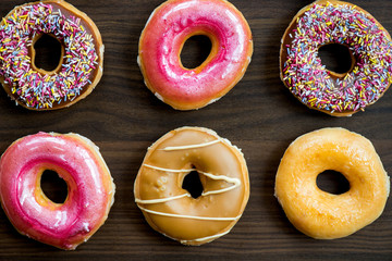 Glazed Doughnuts with colourful sprinkles and icing