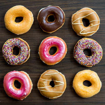 Glazed Doughnuts with colourful sprinkles and icing