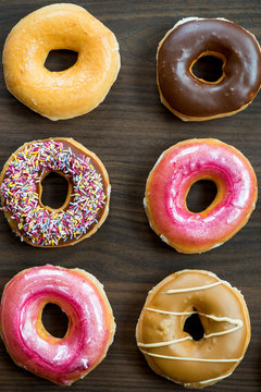 Glazed Doughnuts with colourful sprinkles and icing