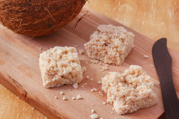 Coconut candy cocada on wooden board