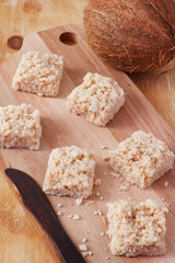 Coconut candy cocada on wooden board