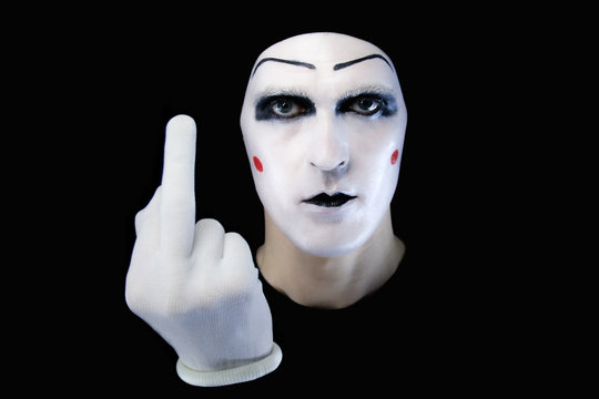 Portrait of the mime in white gloves. fuck you