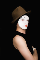 Fototapeta na wymiar Portrait of the mime in a hat on a black background