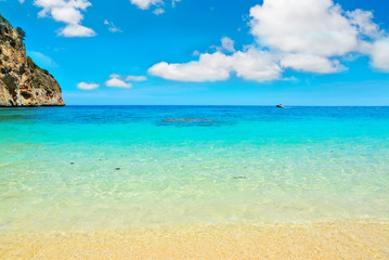 Cala Biriola beach under soft clouds