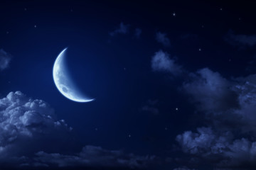 Fototapeta na wymiar Big moon and stars in a cloudy night blue sky