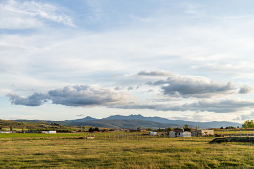 a cloudy landscape of a field near the town
