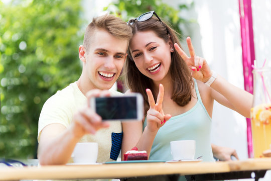 Couple taking selfie with smartphone
