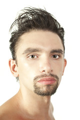 Fototapeta premium Portrait of a young brunette man with a stylish haircut